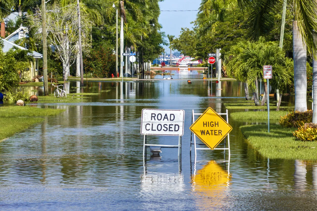 Road closed because of flooding danger with warning signs blocking driving of cars. Hurricane Milton aftermath in Punta Gorda, Florida.